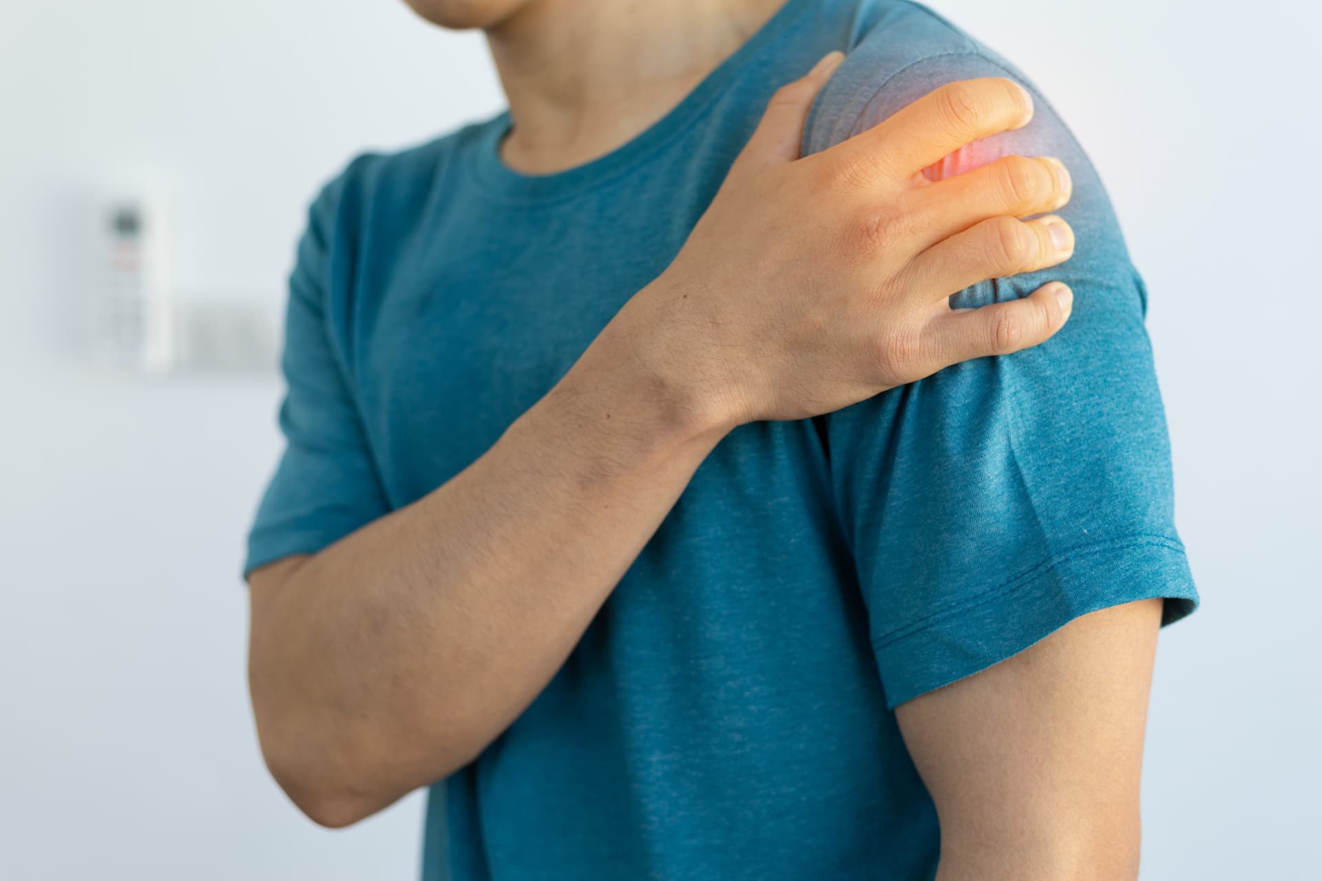 Person experiencing pain around the shoulder.