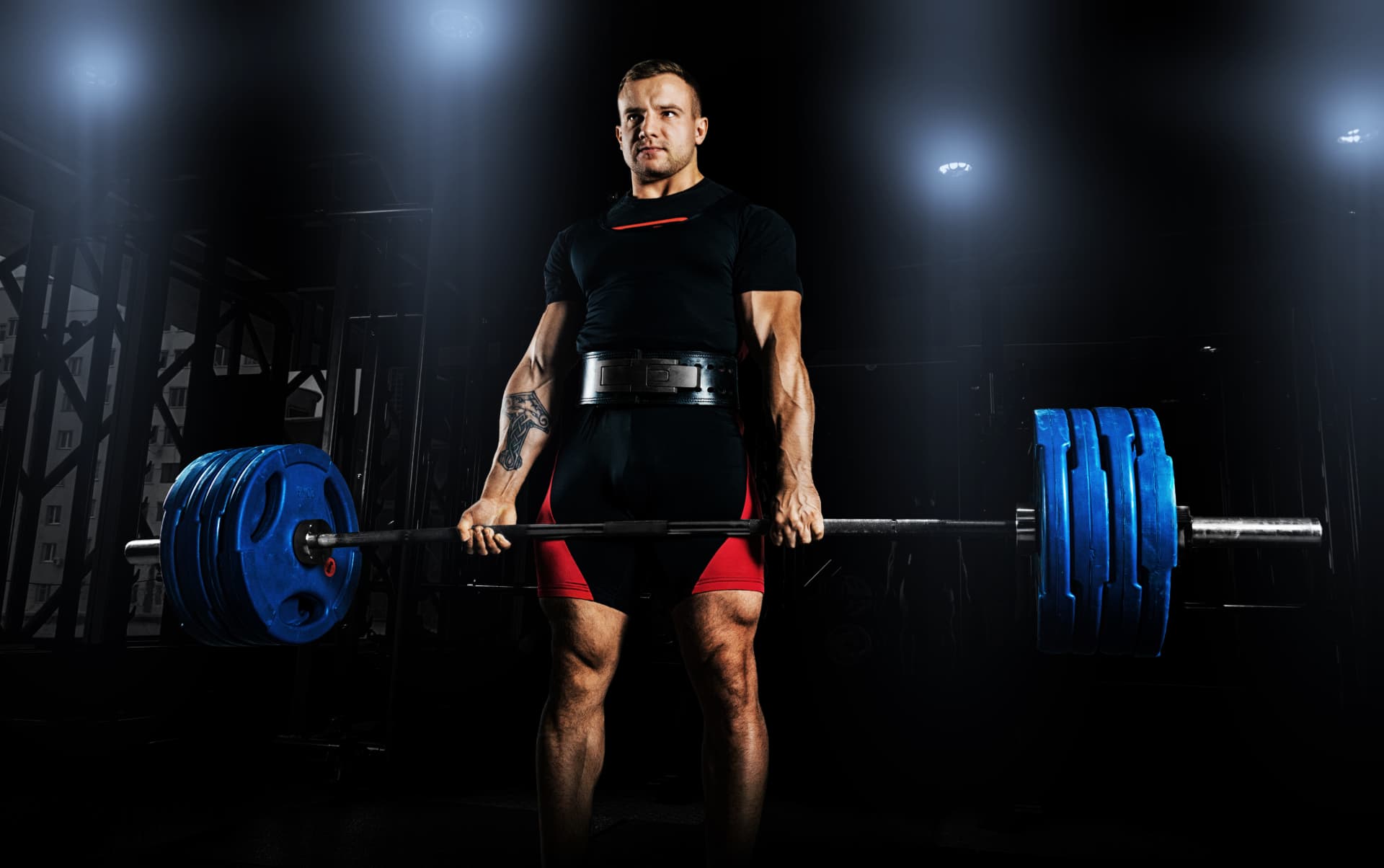 Man performing a barbell deadlift during strength training and physical rehabilitation