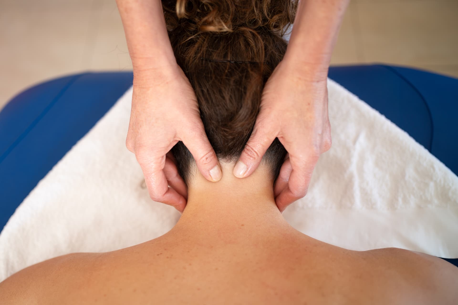 Physiotherapist performing manual therapy to the neck.