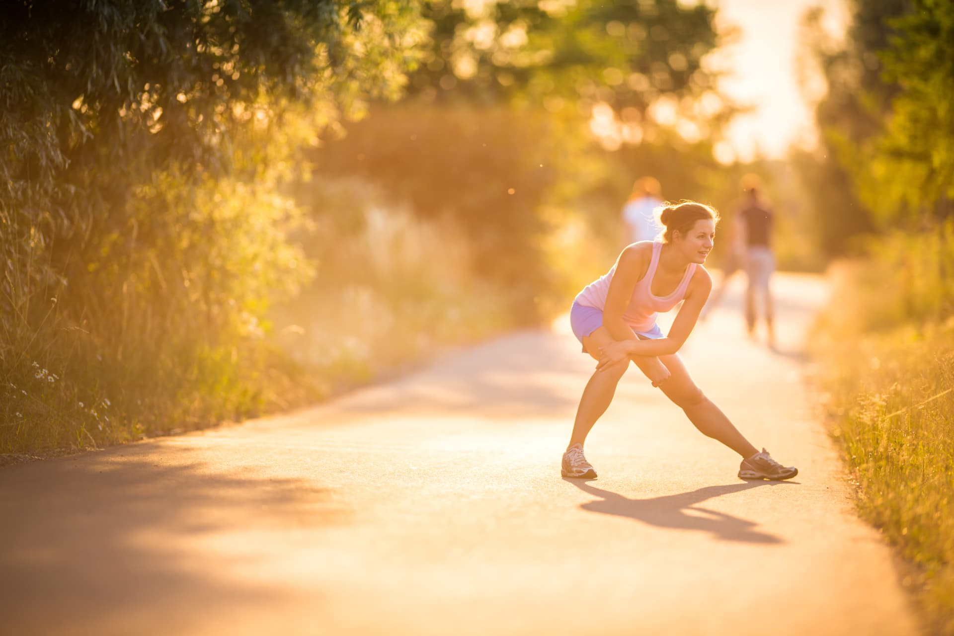 Woman performing a lunge outdoors as part of physical activity and return to movement